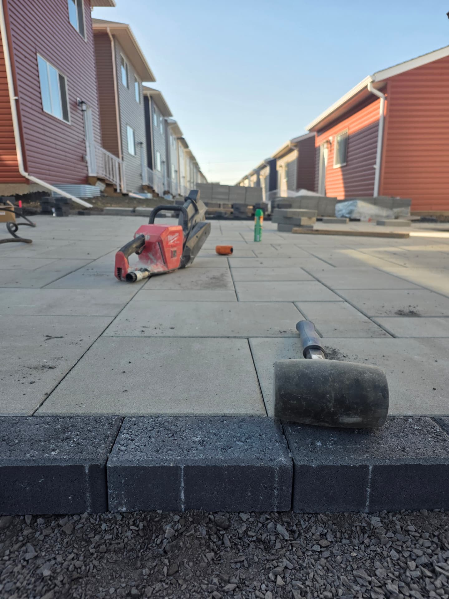 Paver walkway installation with charcoal soldier-course border